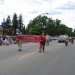 International Falls July Fourth parade - HOCP banner carriers John Rafferty (Member of Parliament, Canada) and Kathleen Przybylski (Voyageurs National Park)
