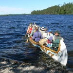 This photo was taken the morning of July 10 as the 4th leg of Canoe the Heart started their voyage leaving from the Boy Scout Camp at Moose Lake.  From bow to stern, paddlers included  Jim Wiinanen, Cook County, MN; Paul Danicic, Friends of the BWCA; Sue Duffy, Superior National Forest; John Craig, volunteer cook; Ann Schwaller, Superior National Forest James Burns, Quetico Provincial Park; Chris Stomberg, Quetico Provincial Park; Michelle Hesterberg, Friends of the BWCA;  John Pierce, Superior National Forest