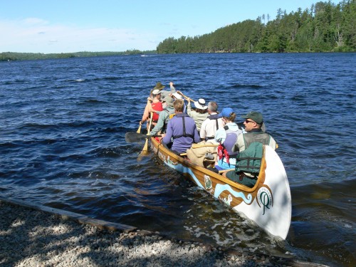This photo was taken the morning of July 10 as the 4th leg of Canoe the Heart started their voyage leaving from the Boy Scout Camp at Moose Lake.  From bow to stern, paddlers included  Jim Wiinanen, Cook County, MN; Paul Danicic, Friends of the BWCA; Sue Duffy, Superior National Forest; John Craig, volunteer cook; Ann Schwaller, Superior National Forest James Burns, Quetico Provincial Park; Chris Stomberg, Quetico Provincial Park; Michelle Hesterberg, Friends of the BWCA;  John Pierce, Superior National Forest