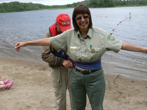 This one is Robin Reilly, Quetico Park Superintendent, trying to turn Lisa into a Voyageur at the Fall Lake event, July 9th.